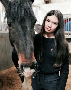 Final-year undergrad economics student Alicja and her horse.
